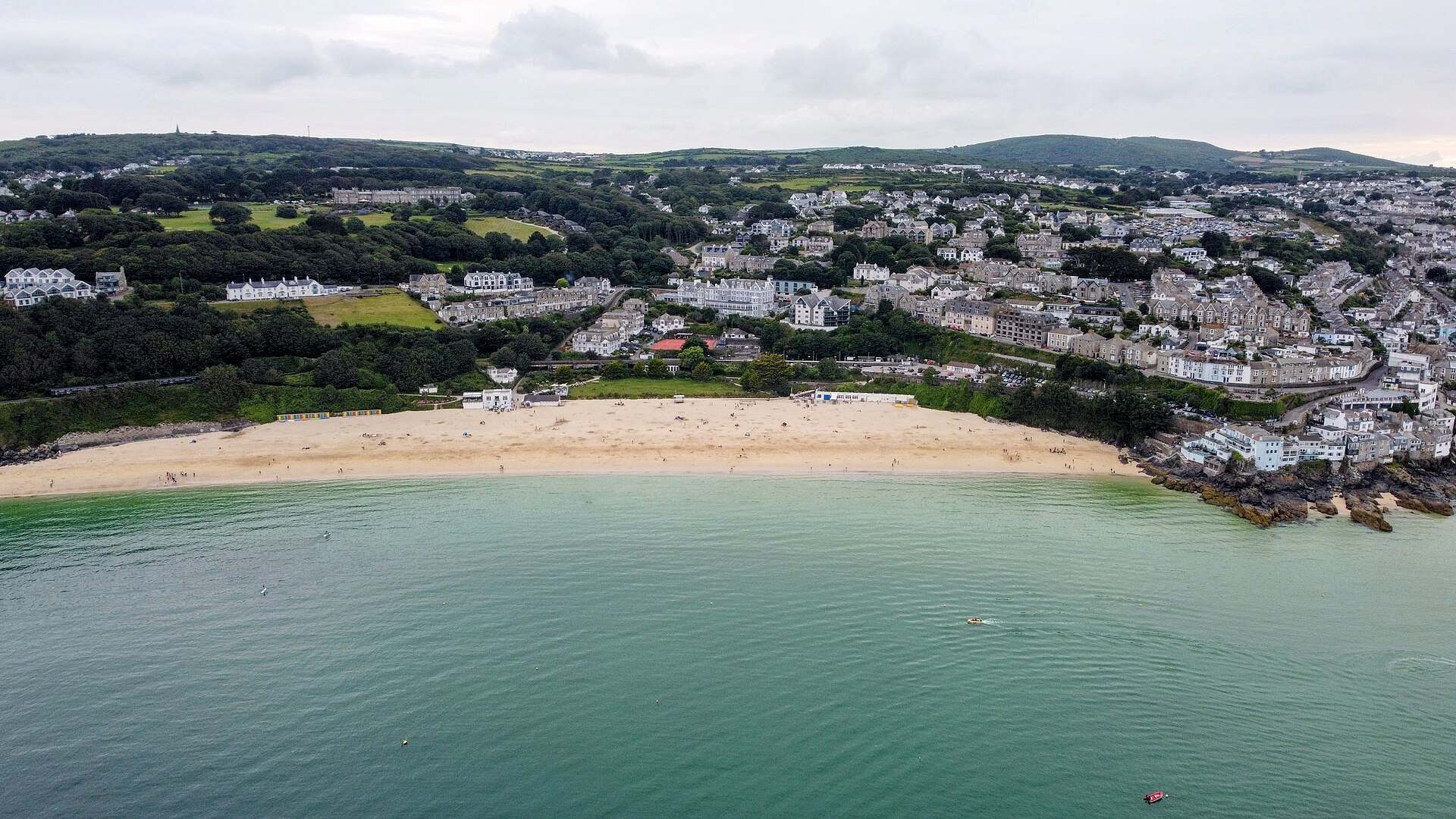 Porthminster Beach at St Ives — sheltered sand and the Godrevy lighthouse on the horizon.