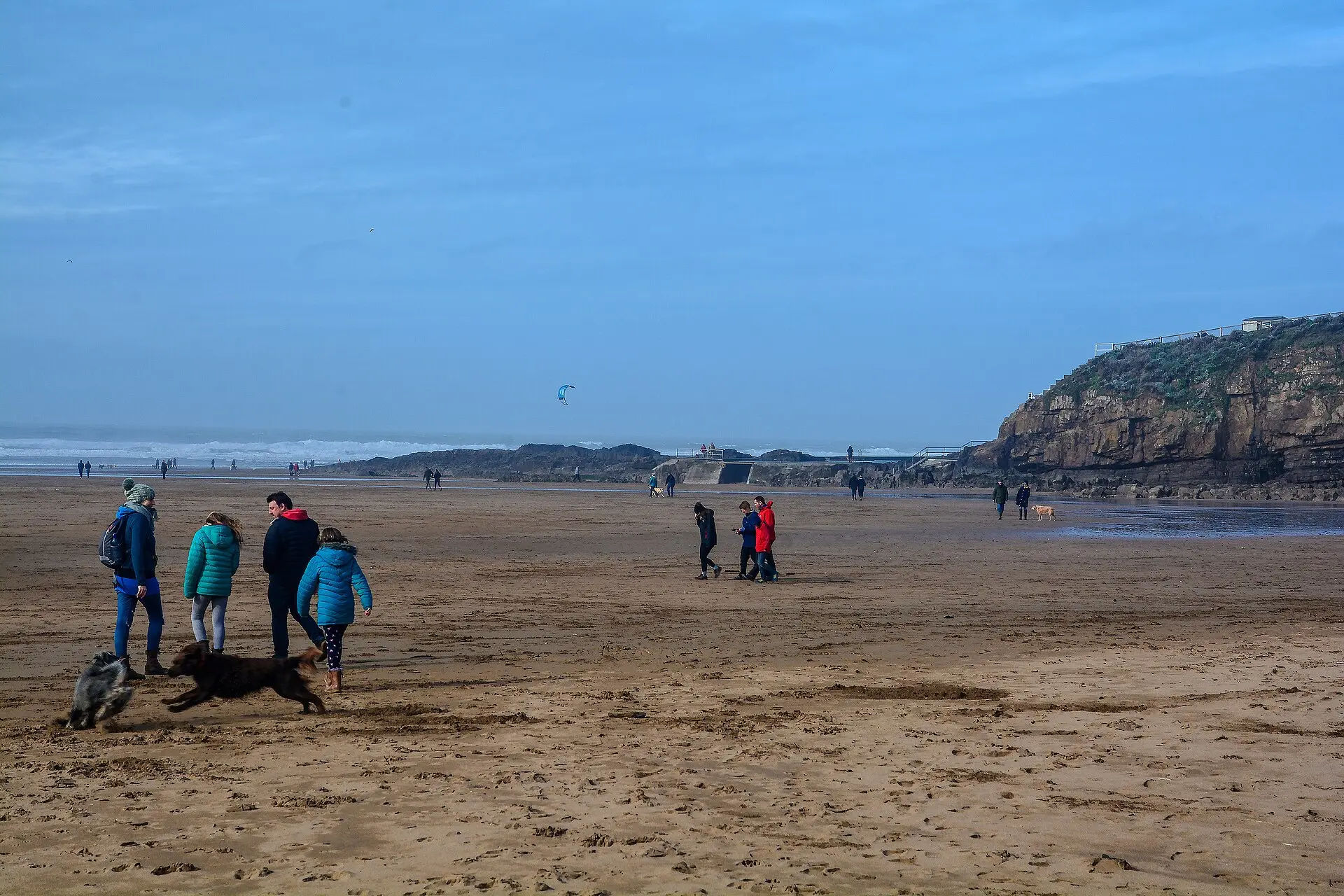 Wide sandflat at Summerleaze Beach, Bude, with the breakwater and cliffs beyond.
