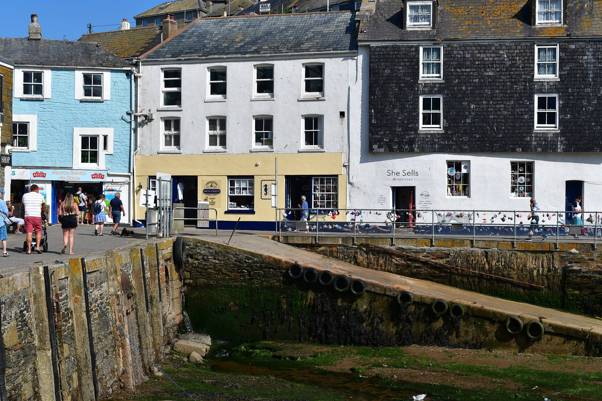 Mevagissey harbour — fishing boats moored against the quay with the village rising behind.