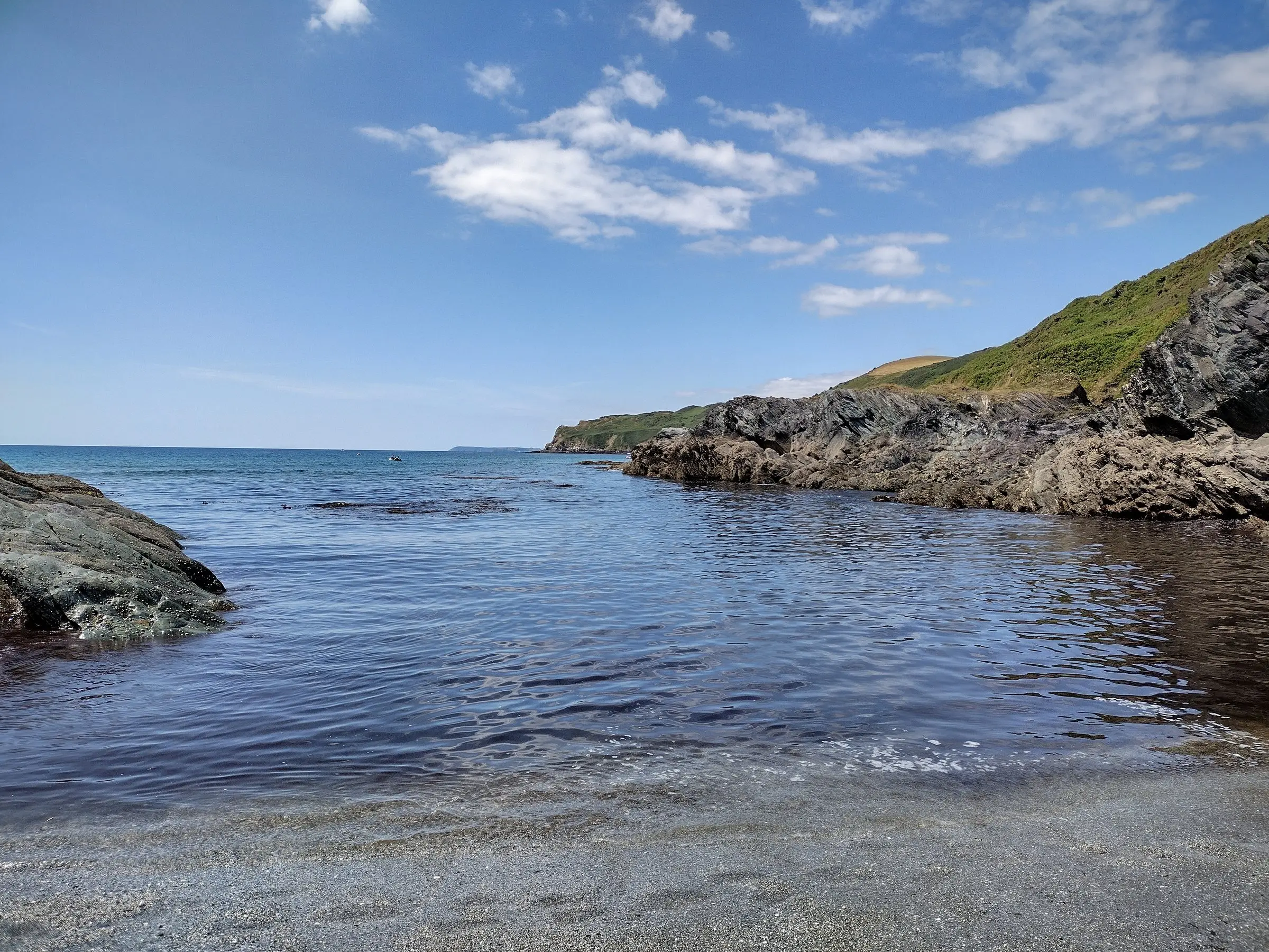 Lansallos Beach — a hidden cove backed by steep wooded cliffs on Cornwall’s south coast.