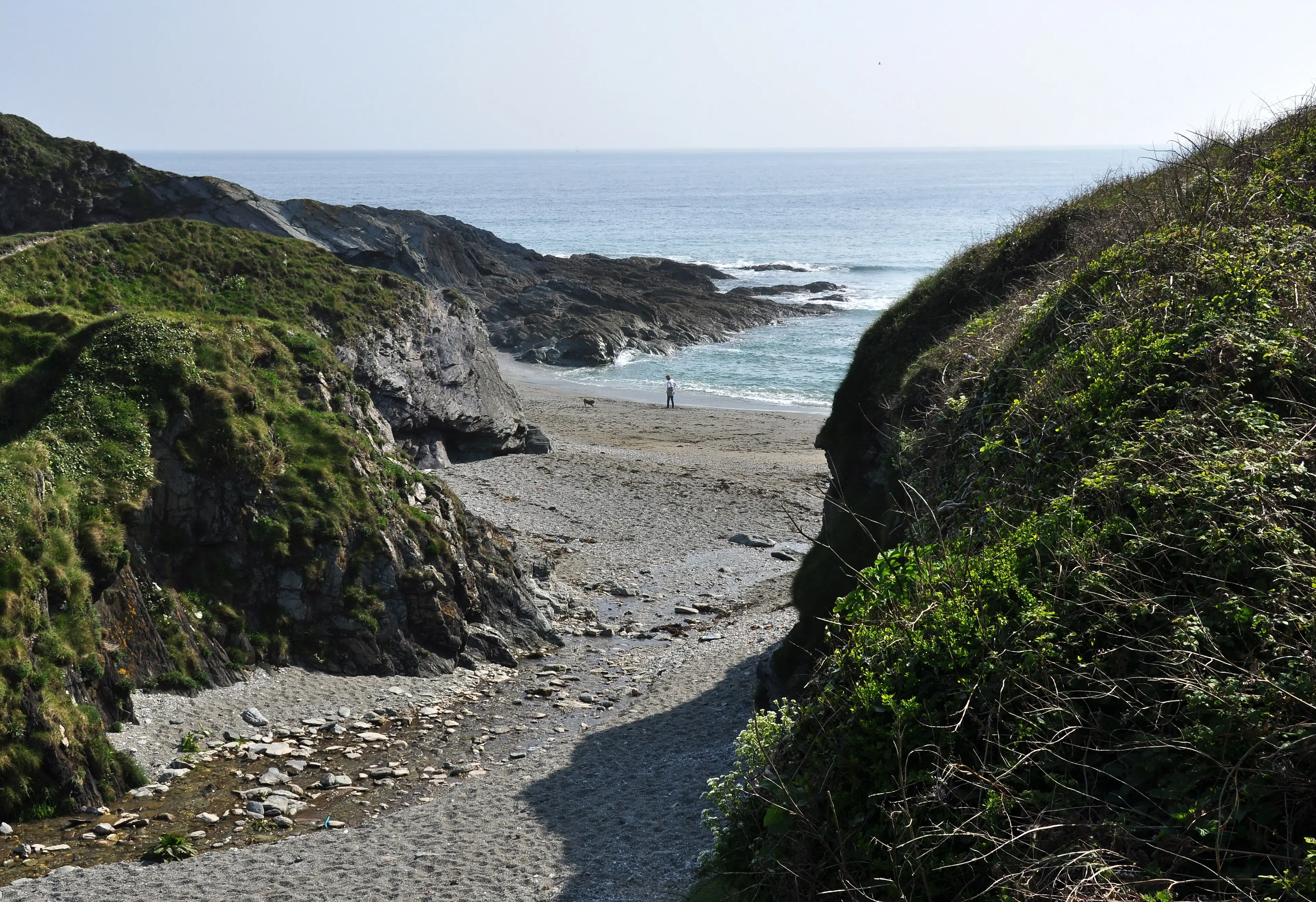 Lansallos beach on the south Cornwall coast — a secluded cove reached by a footpath through woodland.