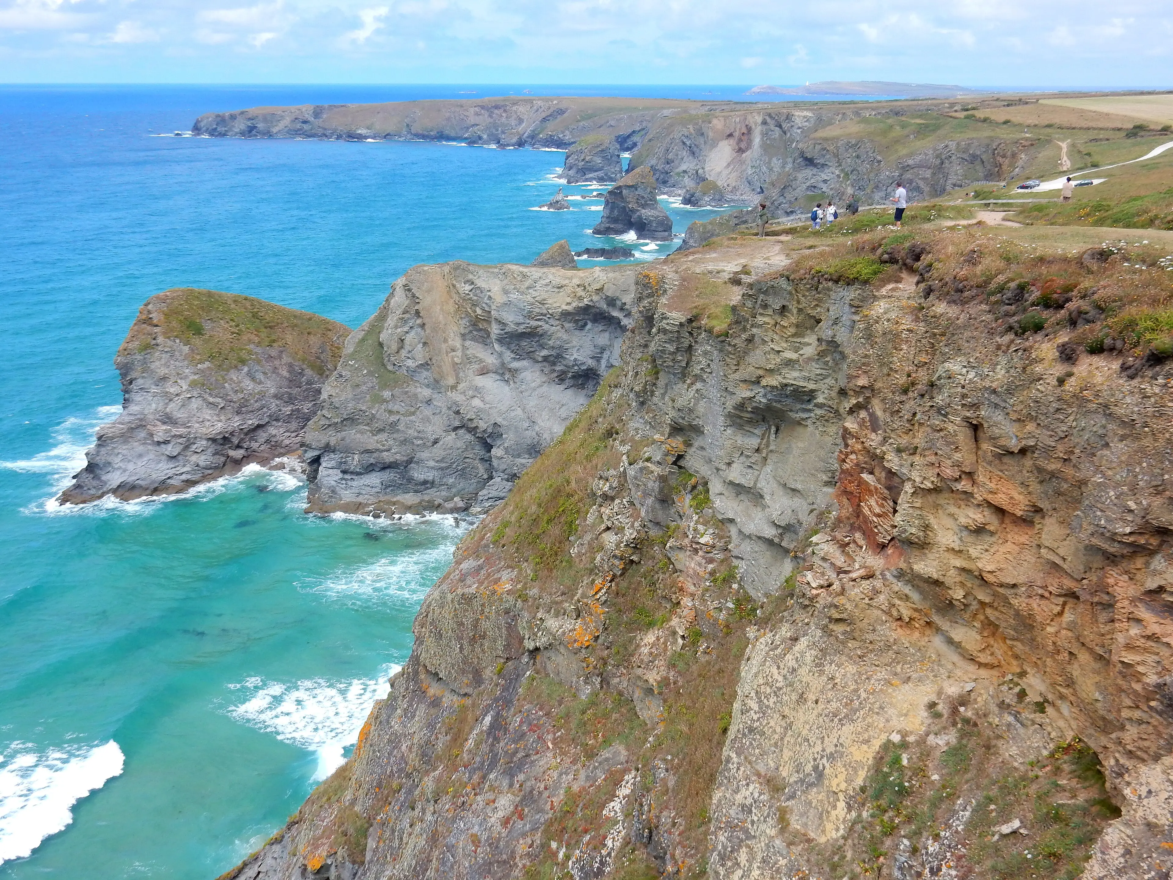 Bedruthan Steps — massive sea stacks rising from a wide sandy beach, one of Cornwall's most dramatic coastal views.