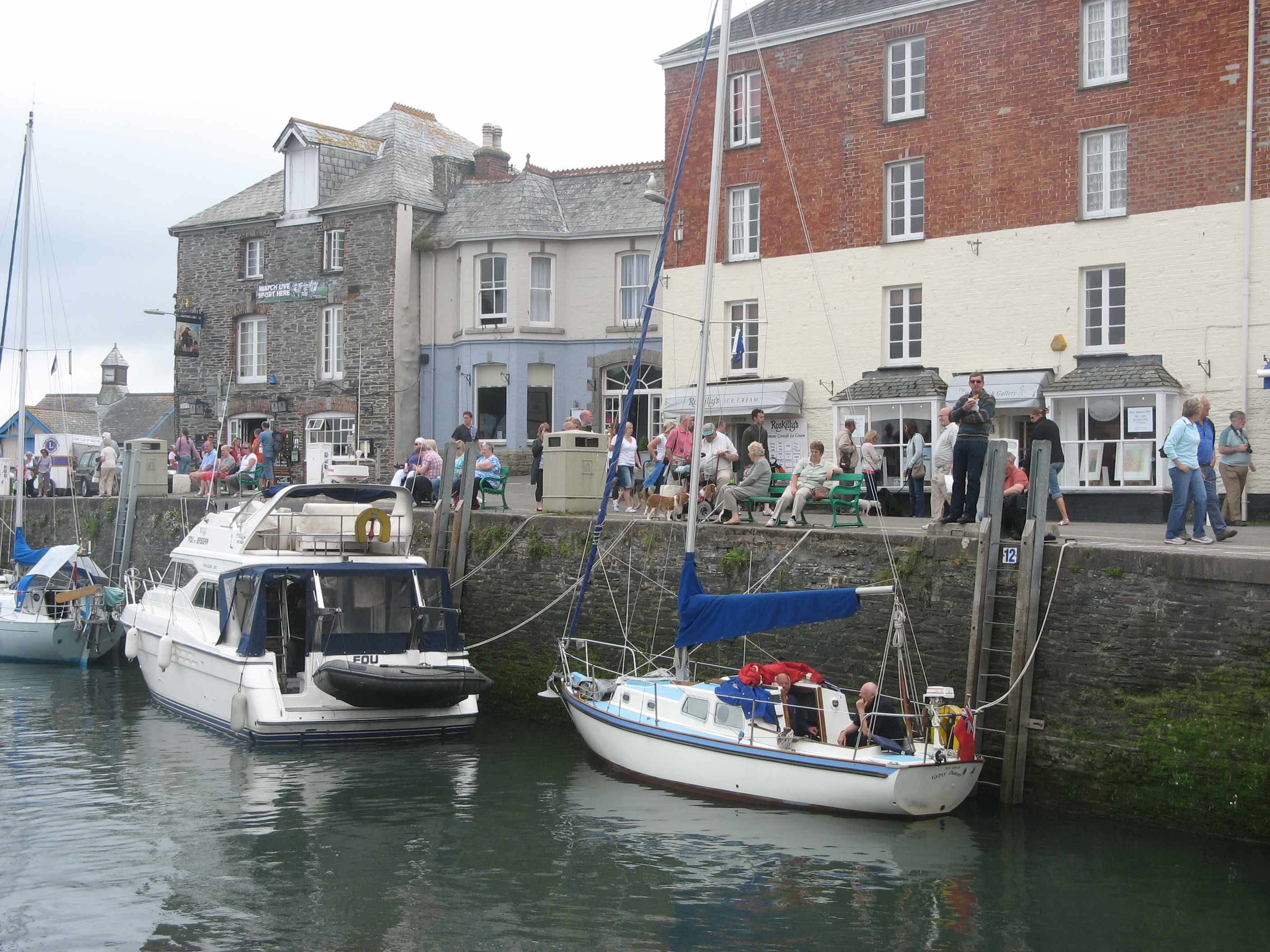 Padstow harbour — fishing boats moored in the estuary at low tide, the working Cornwall behind the tourist trail.