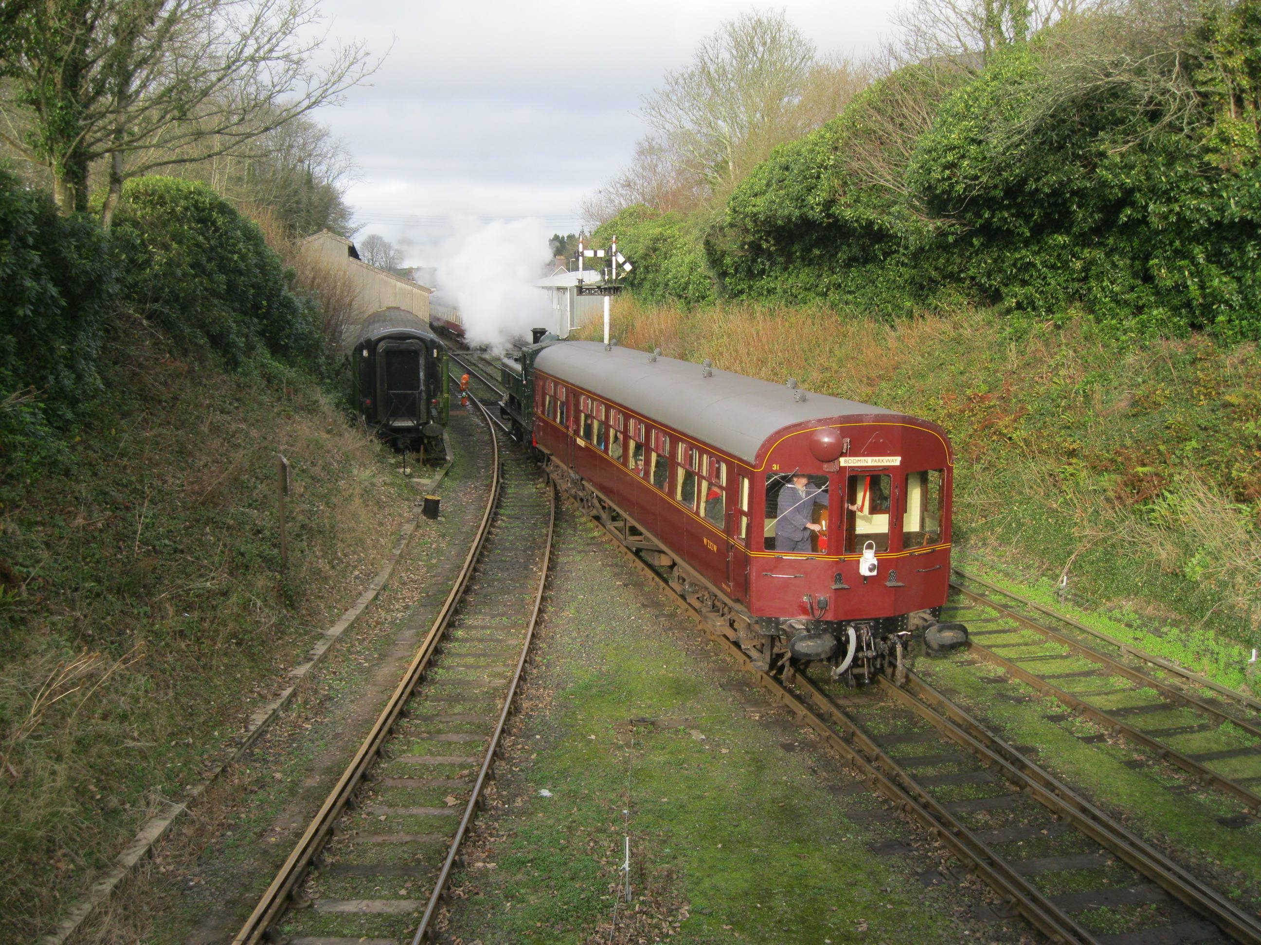The Bodmin & Wenford Railway — a vintage steam locomotive at a Cornish country station, with children watching from the platform.