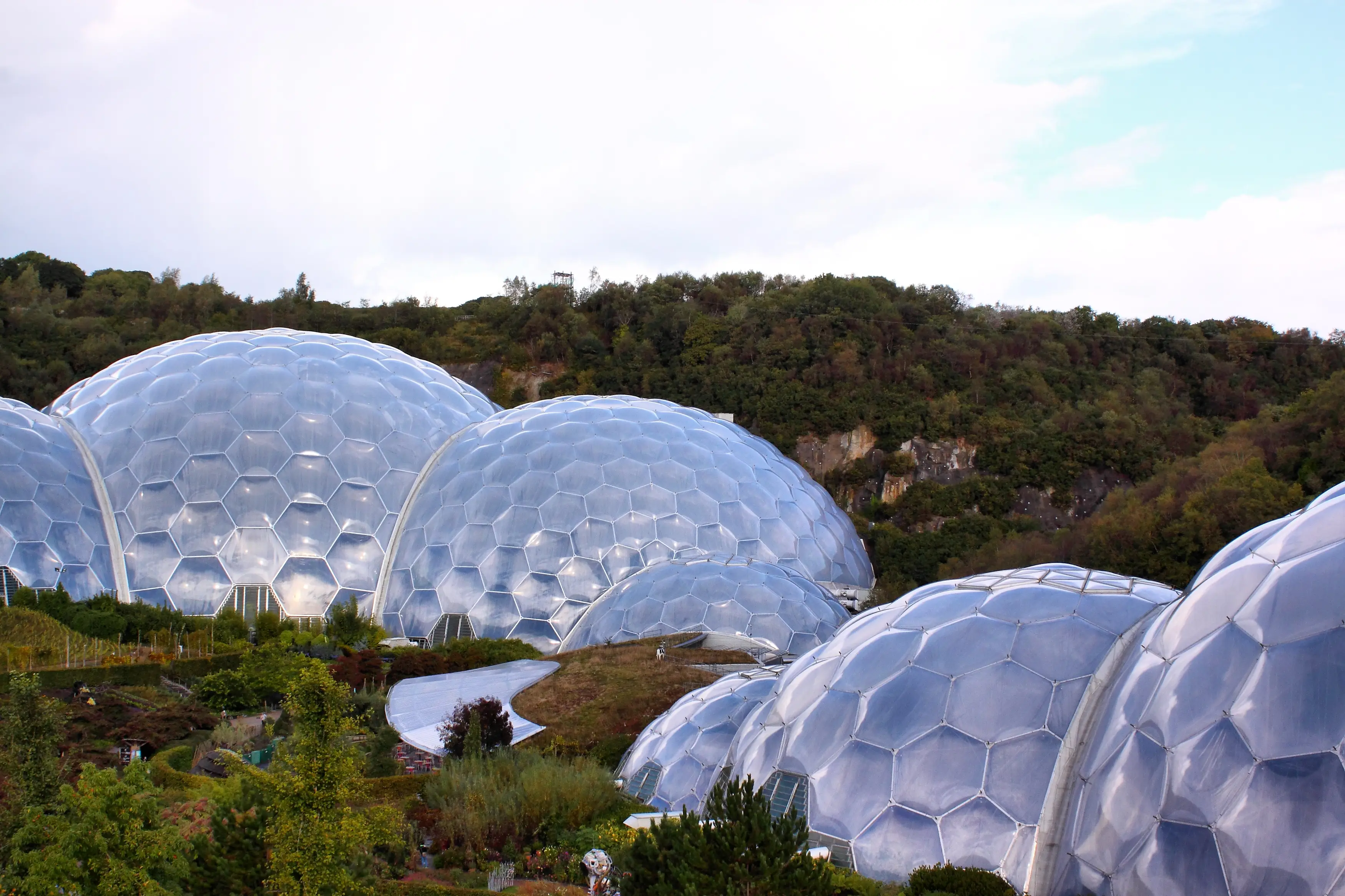 The Eden Project biomes from above — geodesic domes against an overcast Cornish sky.